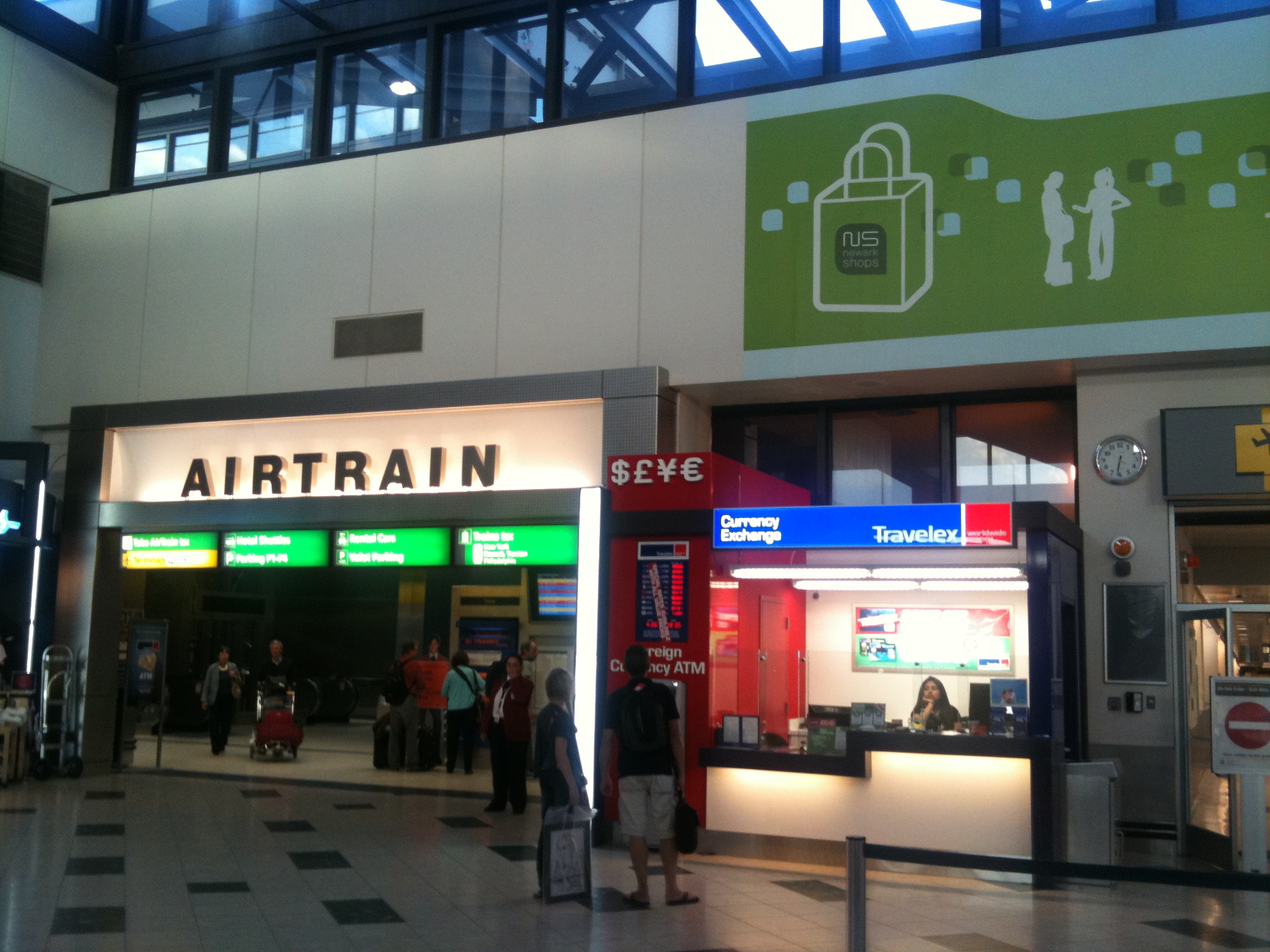 an airport with many passengers standing outside of it