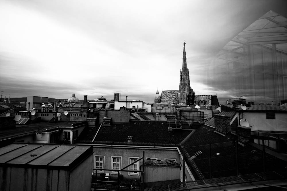 a black and white po of rooftops with buildings