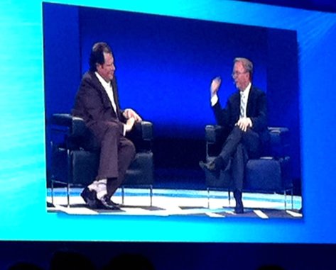 two men in suits on stage talking