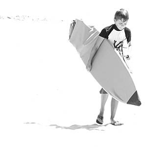 a person standing on the beach with a surf board