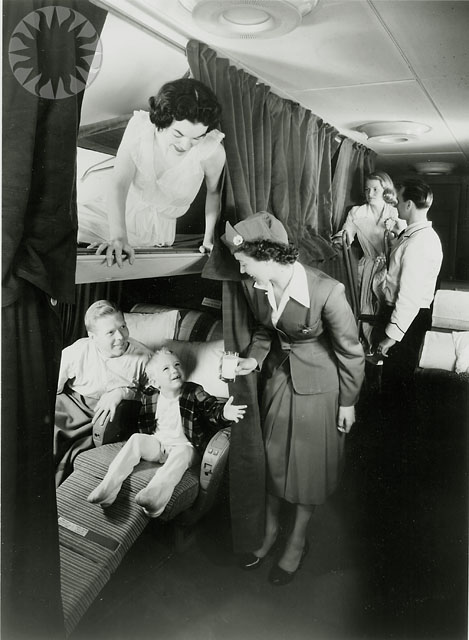 an old po shows people in the airplane with babies