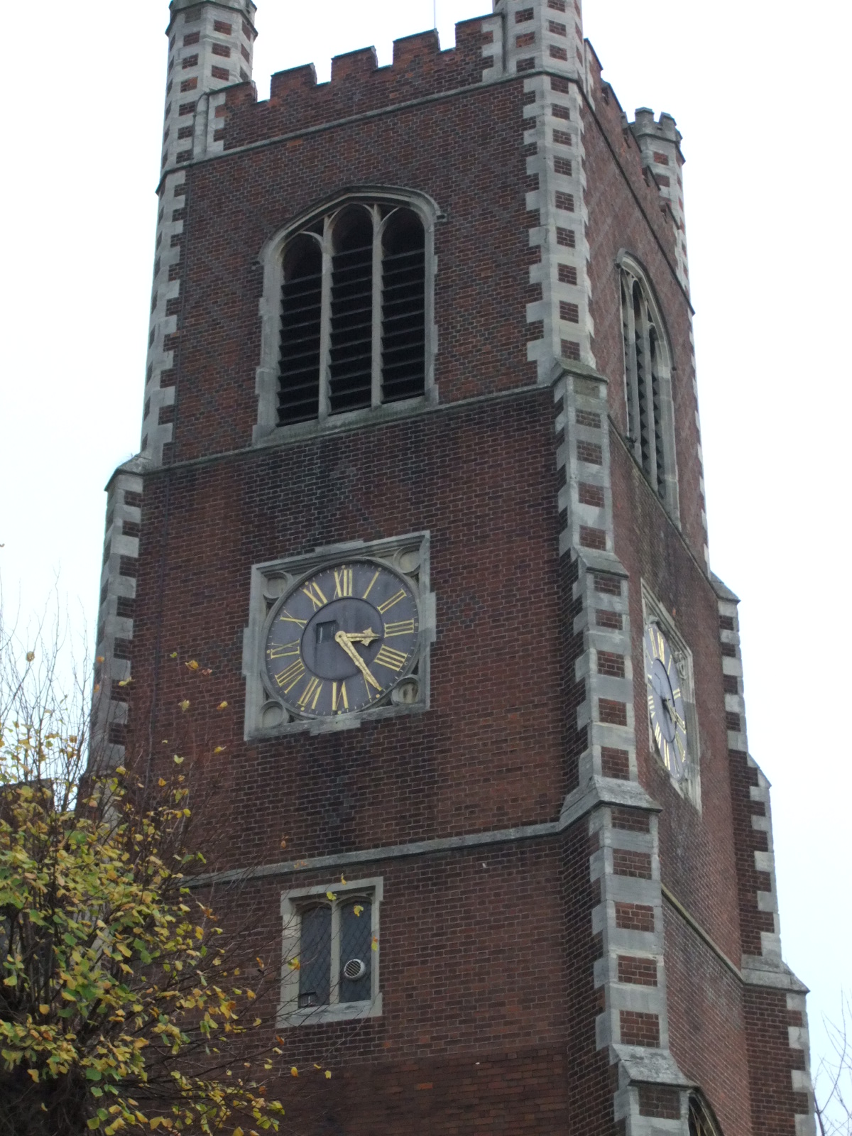 a brick clock tower is shown with two clocks