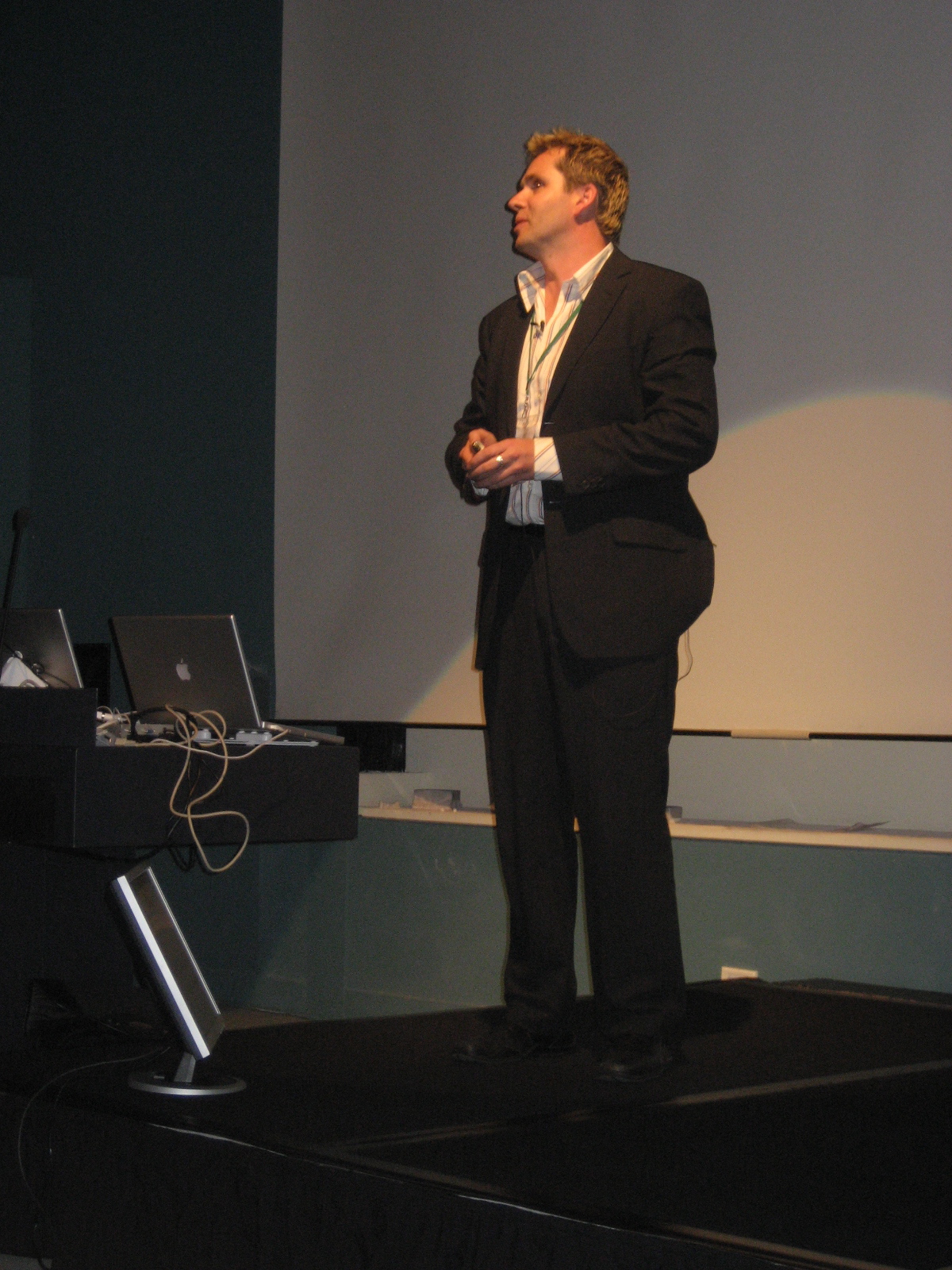 a man giving a presentation while wearing a suite