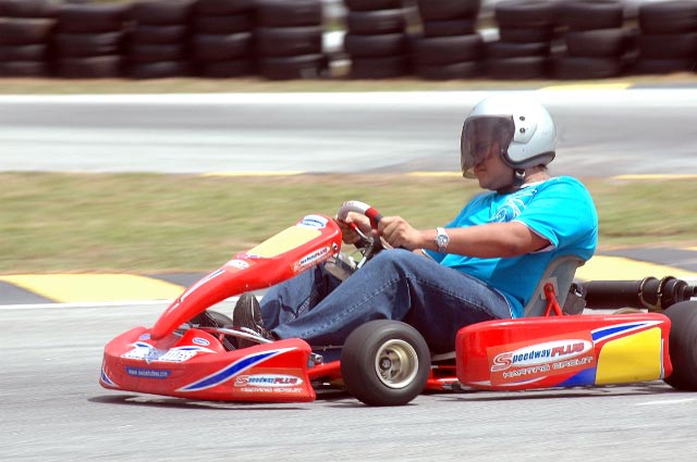 a man driving a kart down the track on it
