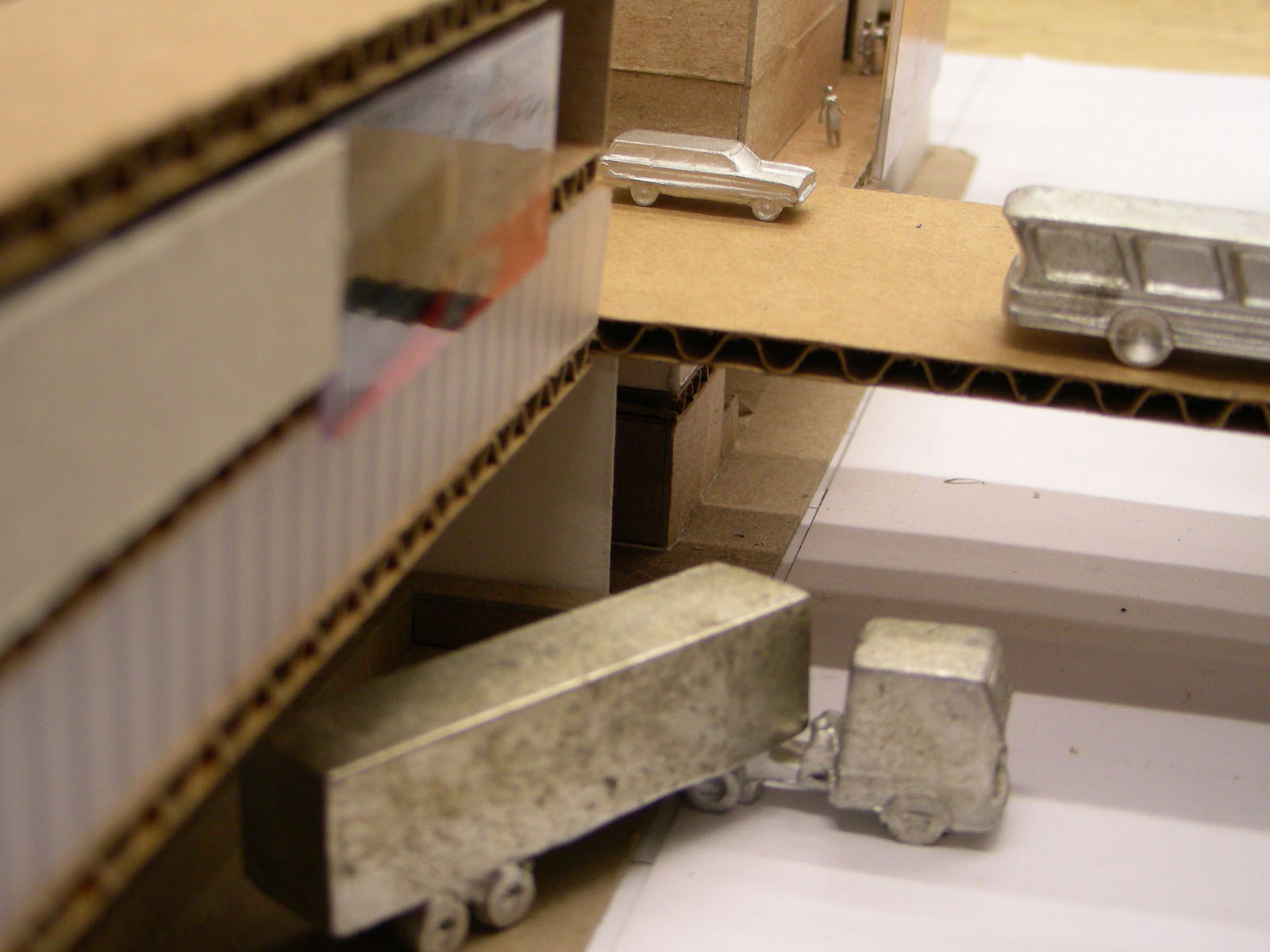 a model truck sits beside some boxes and a ruler