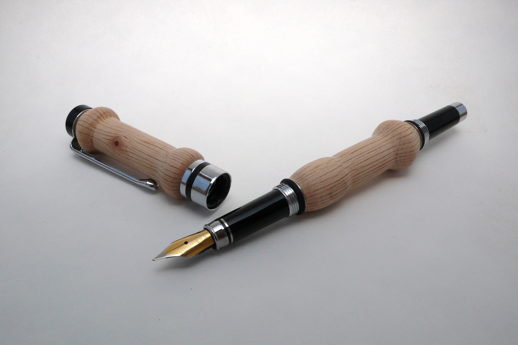 two wood handles on a ball pen