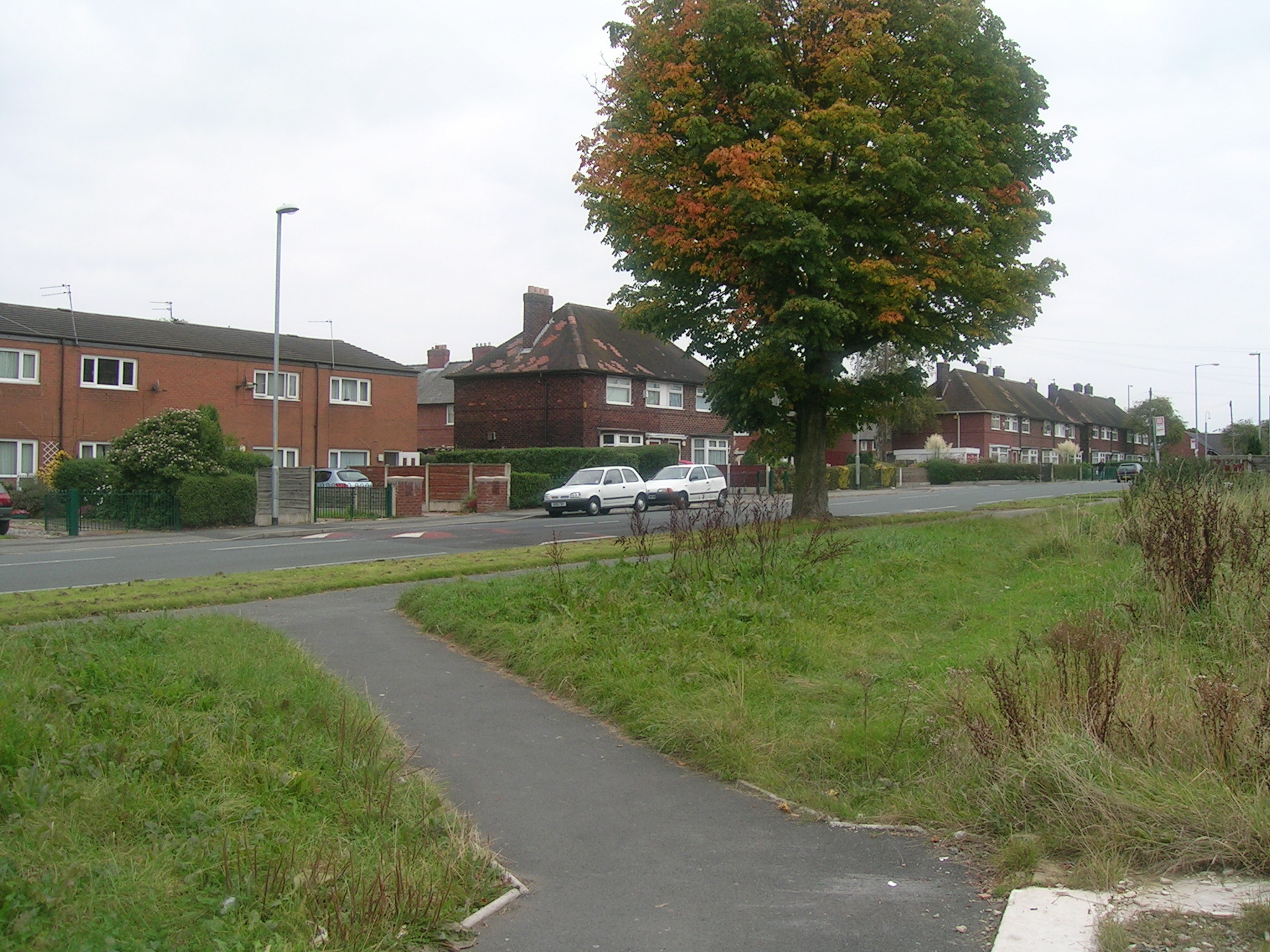 the sidewalk that leads to an empty street