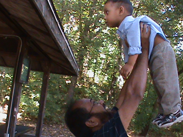a man holding up a young child on his back