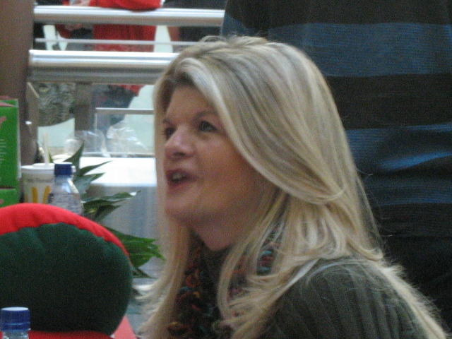 a close up of a person talking at a table