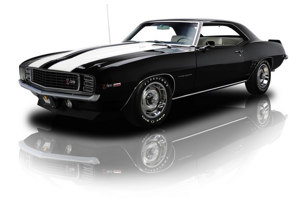 a black and white image of a classic muscle car