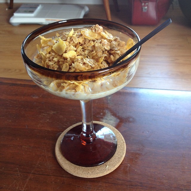an ice cream parfait with toppings in a glass bowl