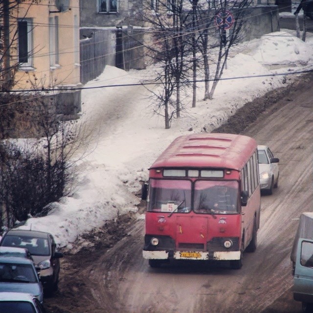 cars and a bus on a snowy road