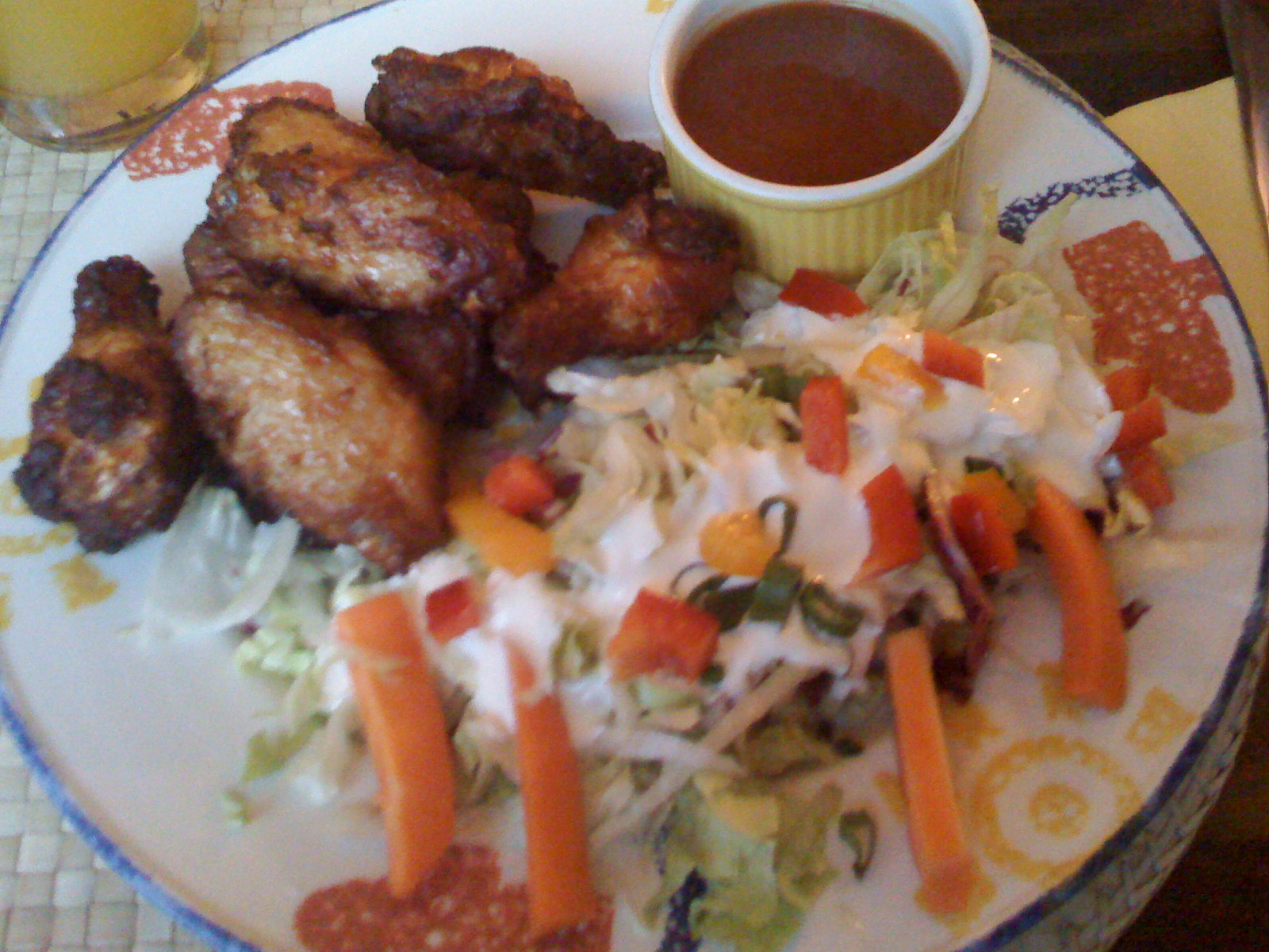 a dinner plate with carrots, coleslaw and fried chicken