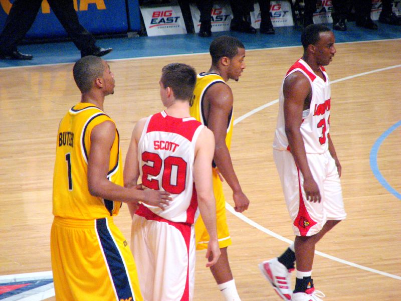 several basketball players in uniforms are standing on the court