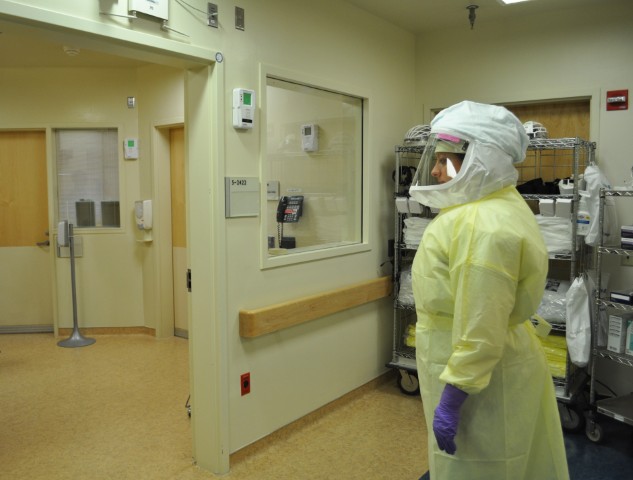 an employee is dressed in protective clothing and a white mask