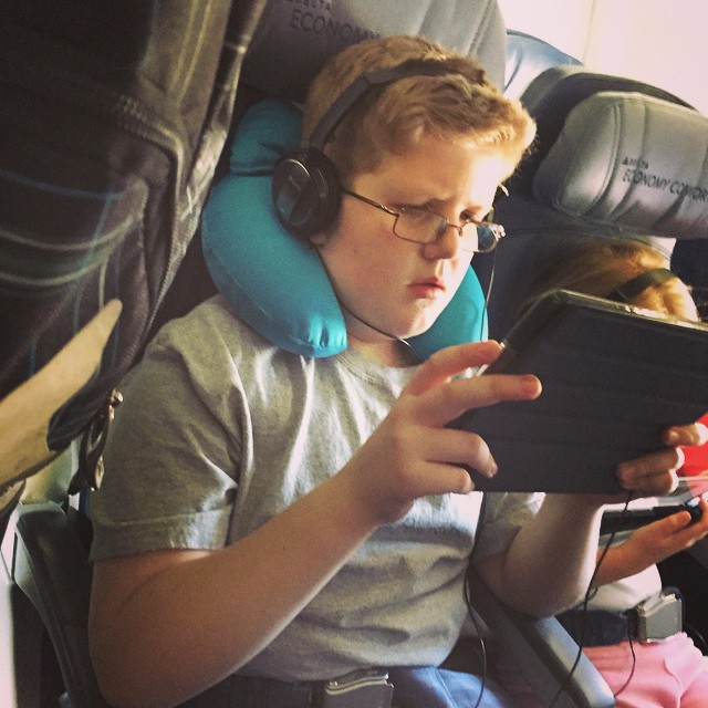 a little boy wearing headphones and ear phones