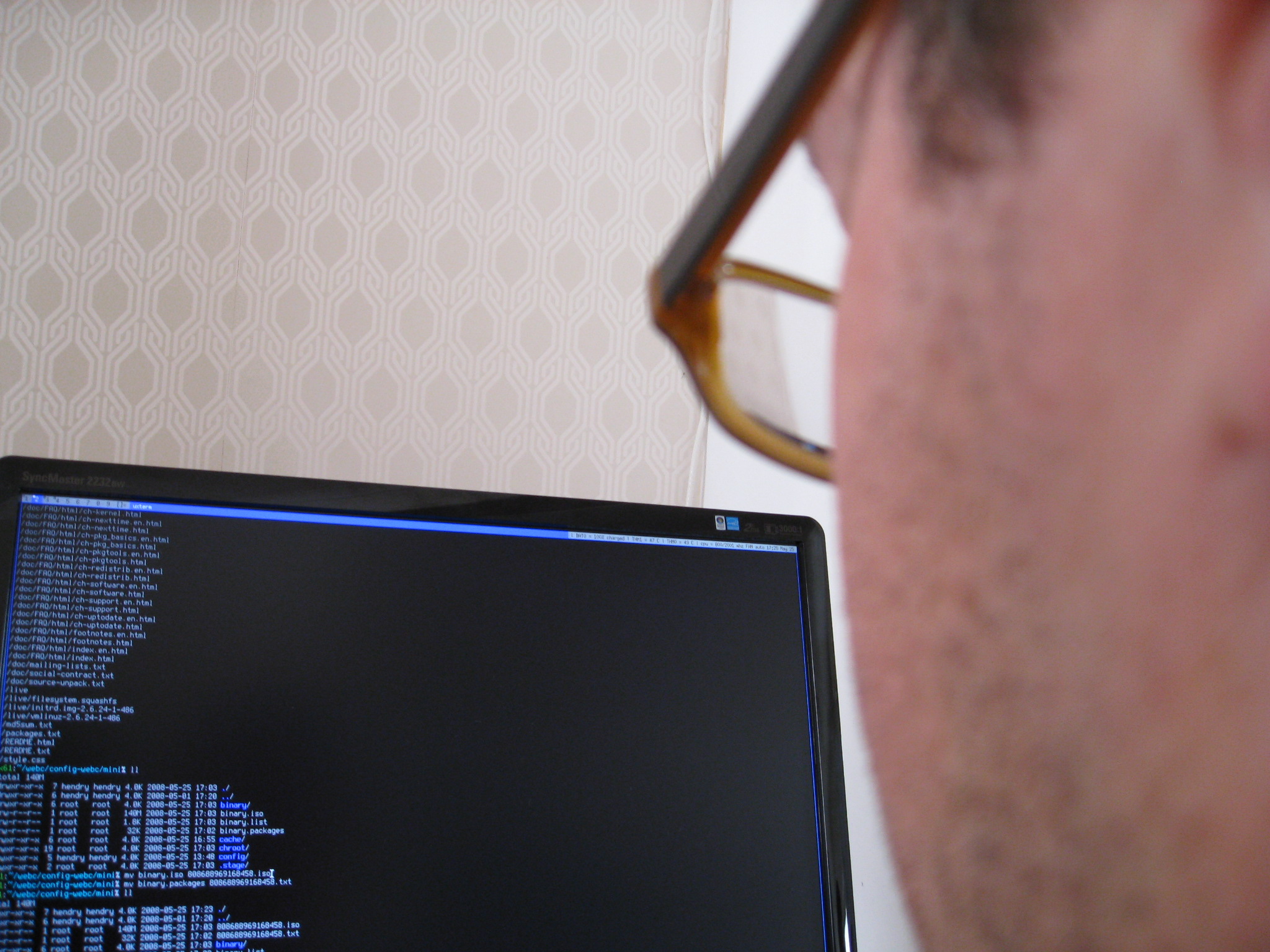 a computer screen in front of a man's eye wearing glasses