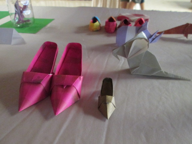 a couple of paper shoes on a table