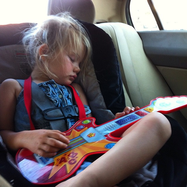 the child is sleeping in her car seat