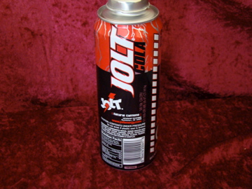 a small can of alcohol sitting on top of a red carpet