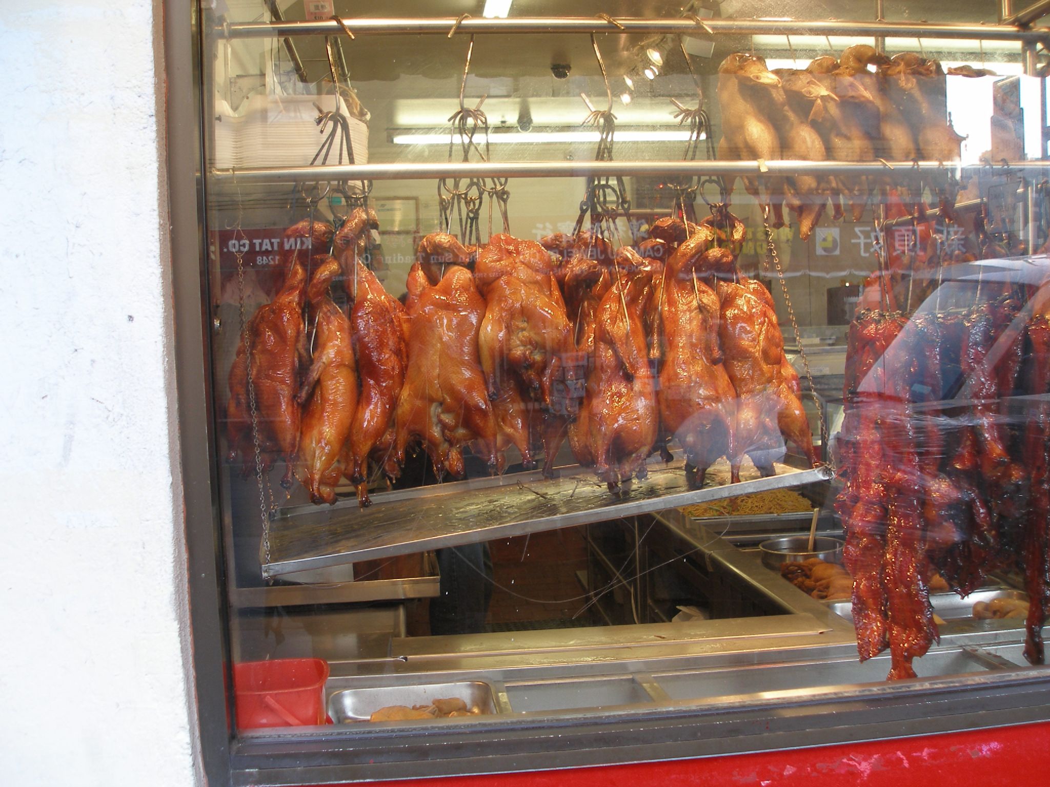 some meat hanging from the ceiling in a store