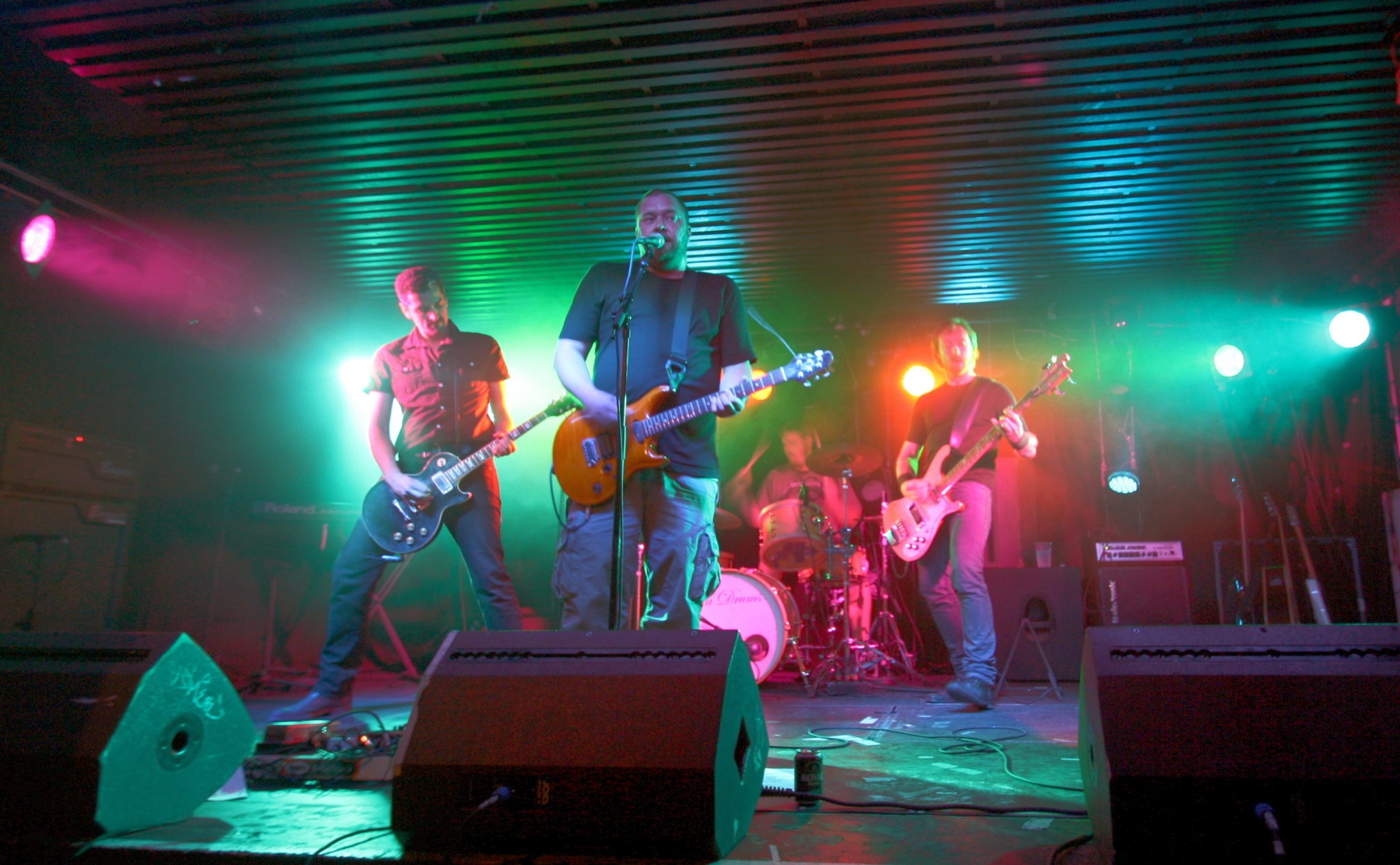 band on stage playing live music on a very dark night