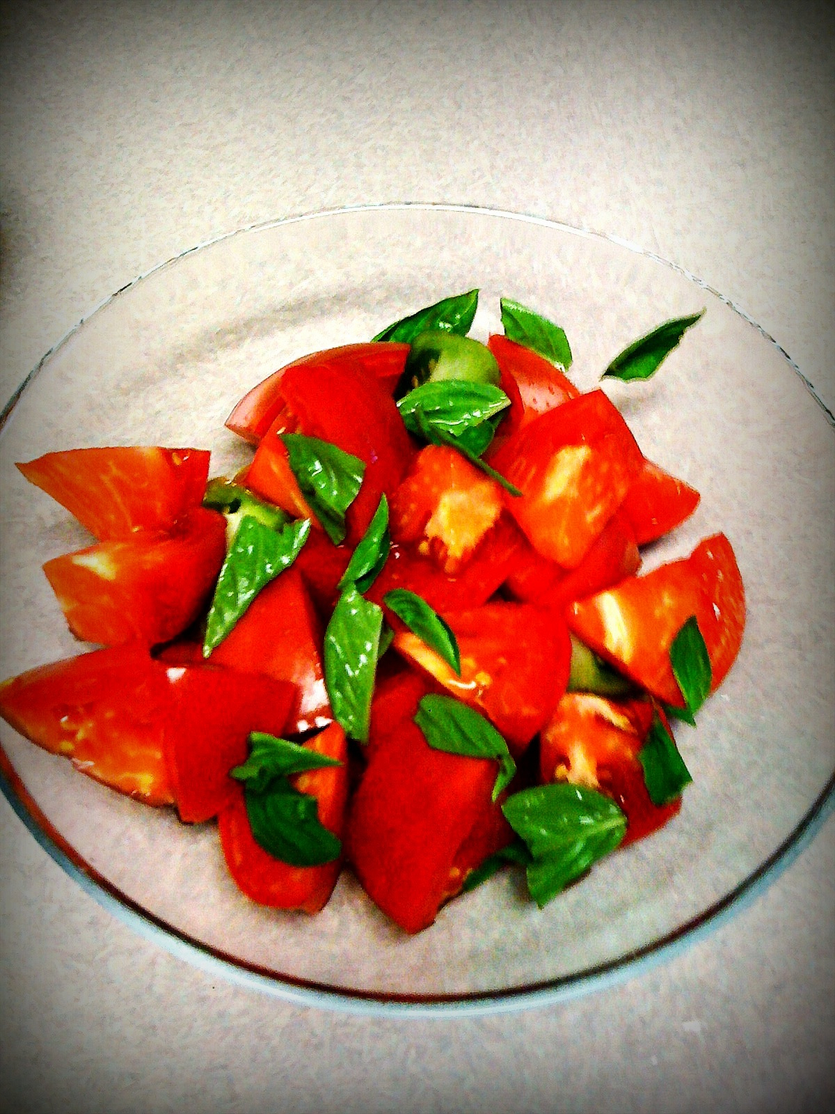 some cut up tomatoes with green leaves on the top