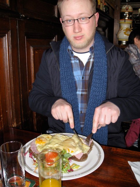 a man with glasses  up food on a plate