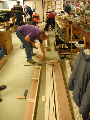 a man is in a workshop making wooden furniture