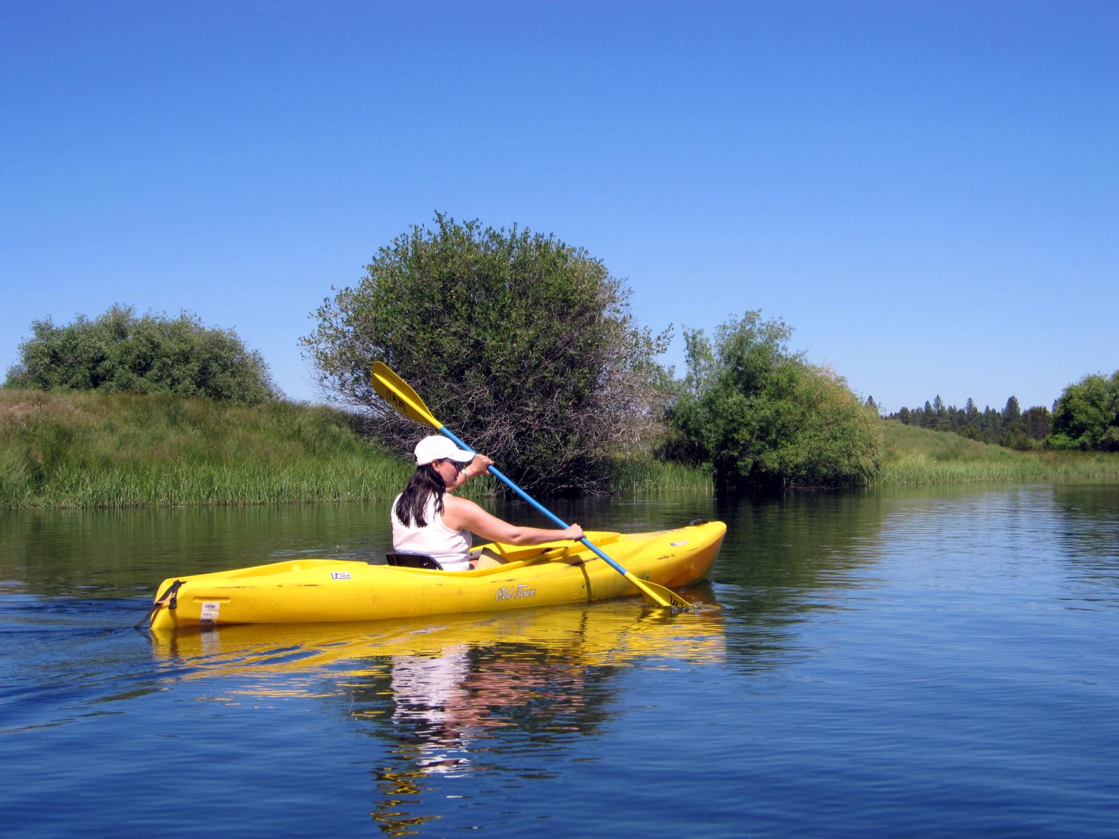 a woman is in a kayak on a lake