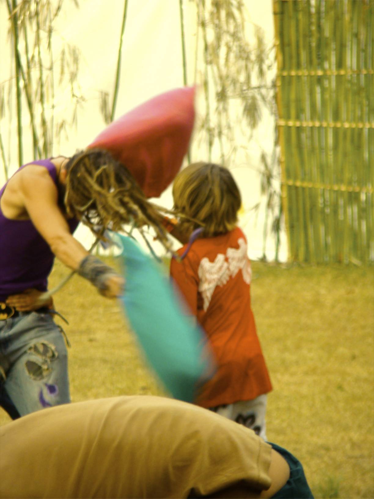 a woman standing next to another person holding a frisbee