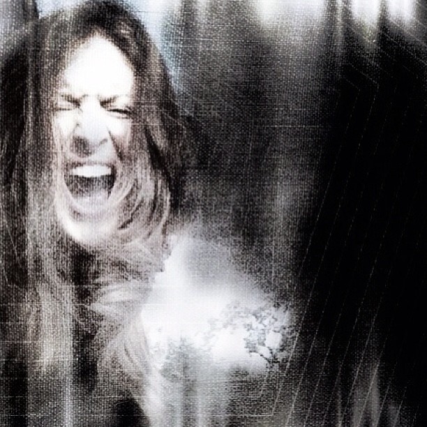 a woman screaming while in a grungy po