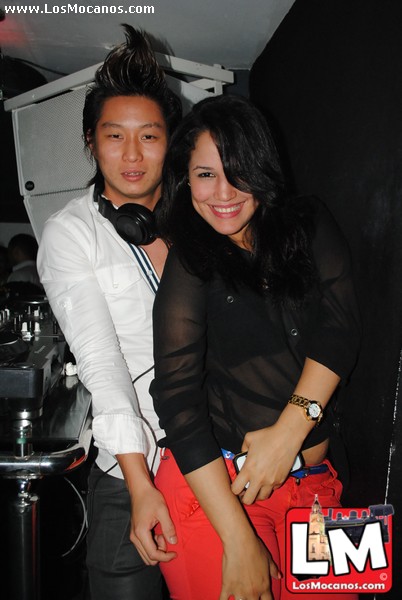 a man and woman posing together at a club