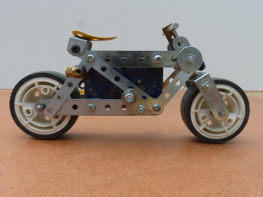 a metal toy tricycle with no rear tires