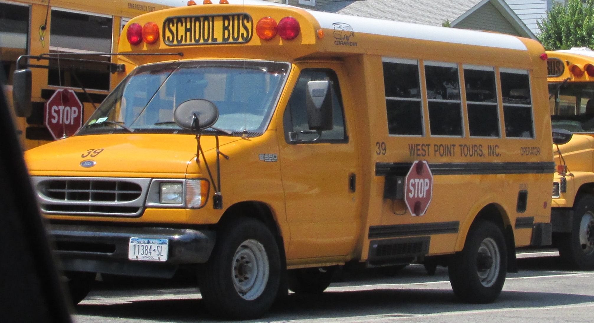 several buses parked on the side of the road