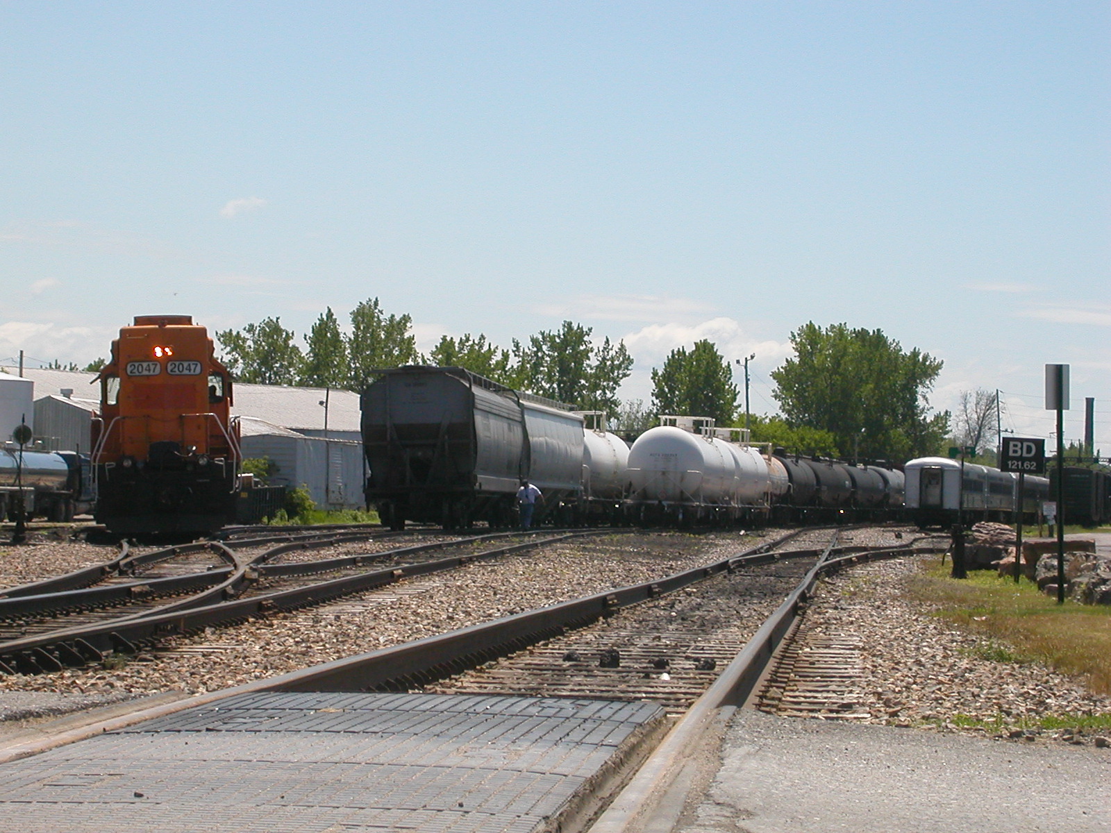 train yard with freight cars and trees