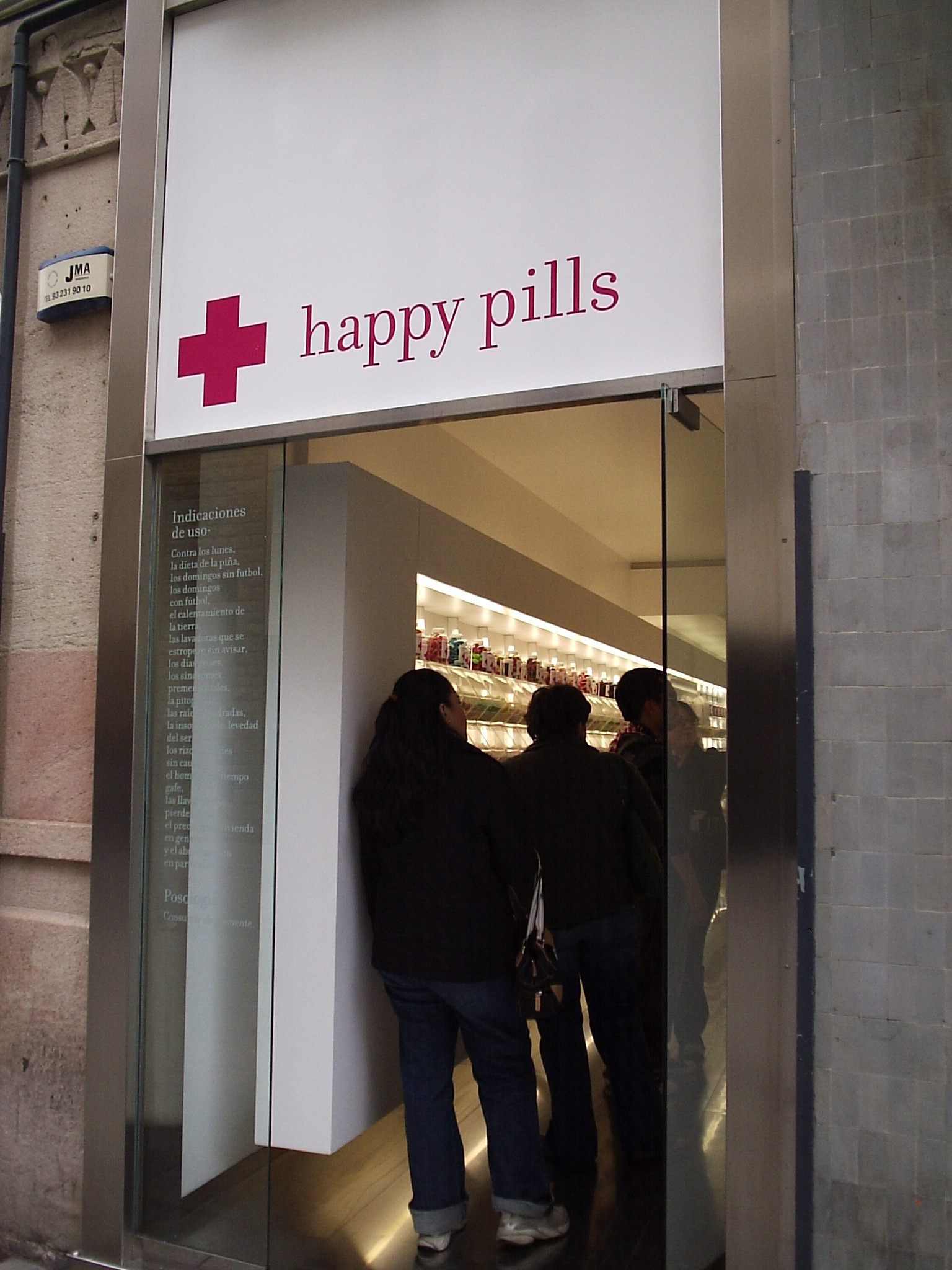 people are entering a pharmacy while one holds onto his belt