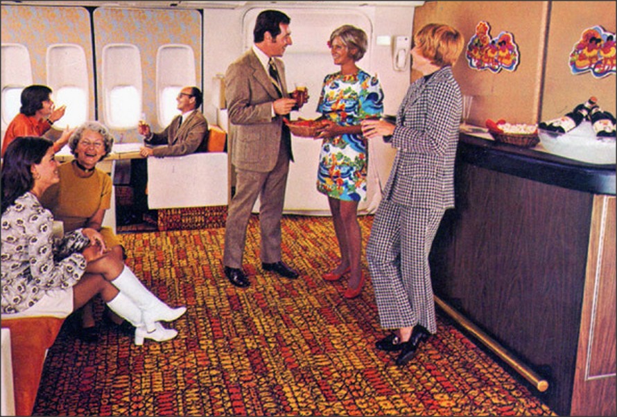 this airline room is full of passengers having drinks
