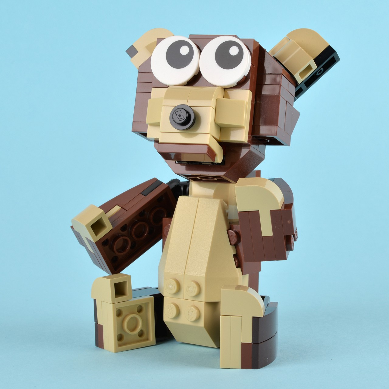 a close up view of a lego robot holding a small brick