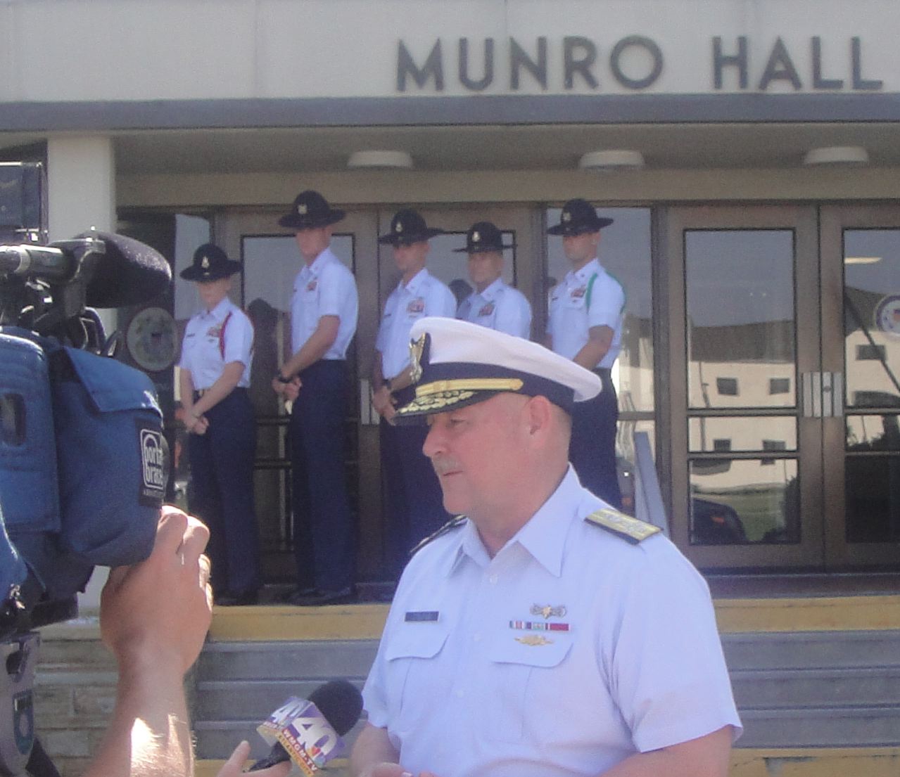 a man in a uniform talking to the press