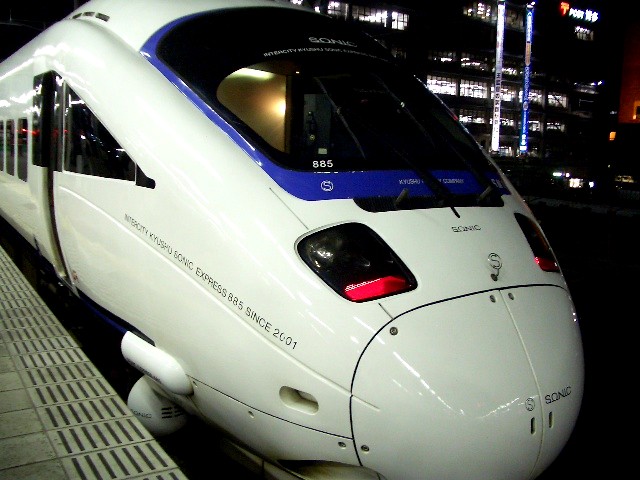 a sleek white passenger train in the city