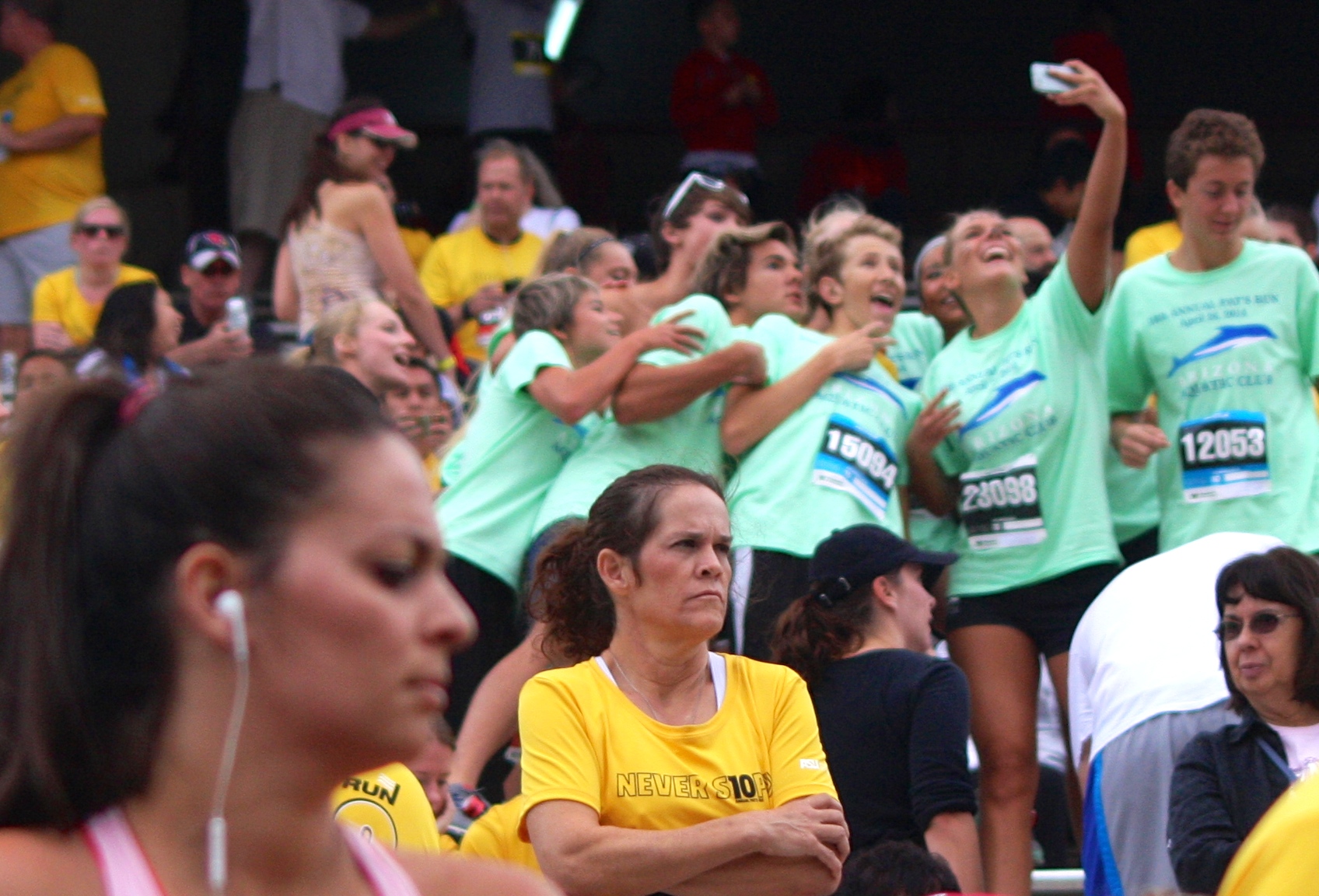 people wearing green shirts watch as a race begins