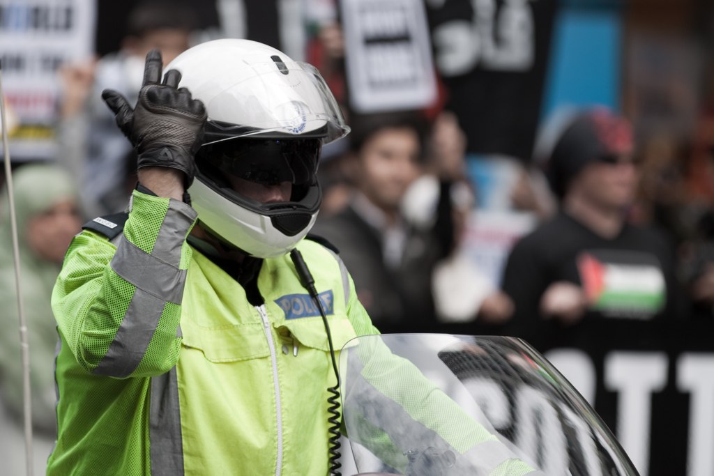 a man wearing a helmet waving a peace sign