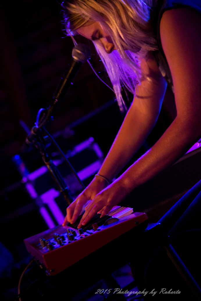 a woman is bending over with her hands on a keyboard