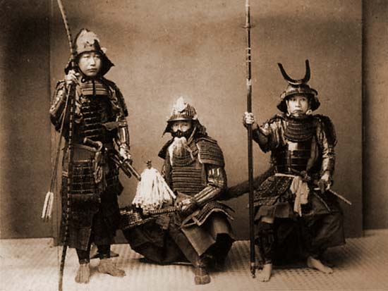 the people are wearing traditional japanese garb and holding a spear