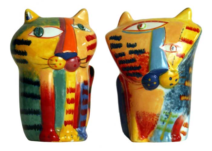 two colorful cats are standing next to each other