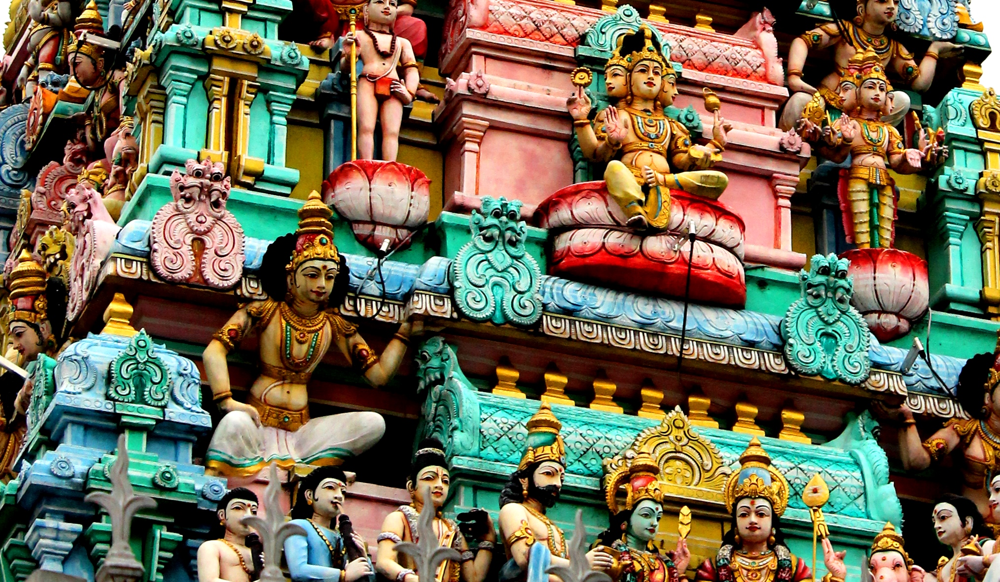 an ornate indian architecture with different color and statues