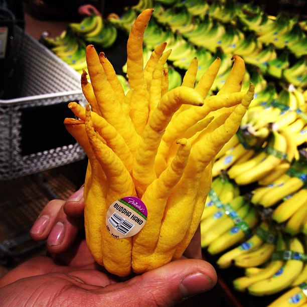 a hand holding bananas that have been turned into sticks