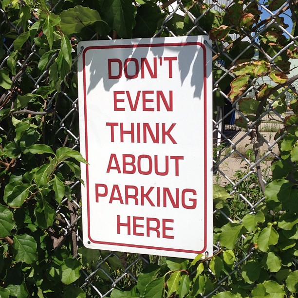 an image of don't even think about parking here sign