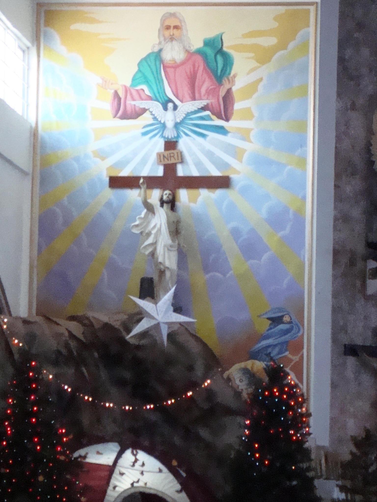 the crucifix is covered in a colorful painting